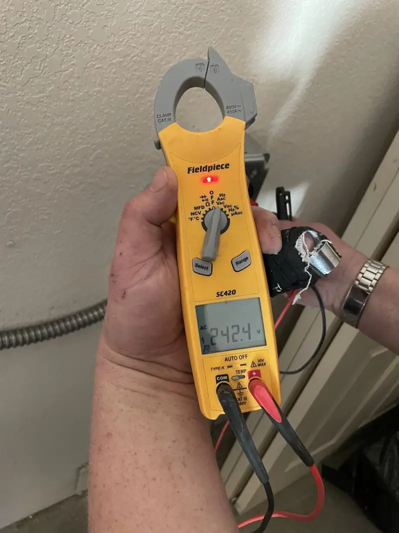 Voltage testing with clamp meter during Ceiling Fan Installation in London Britain